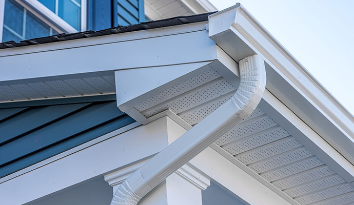Clean and bright roof gutter system along the edge of a roof