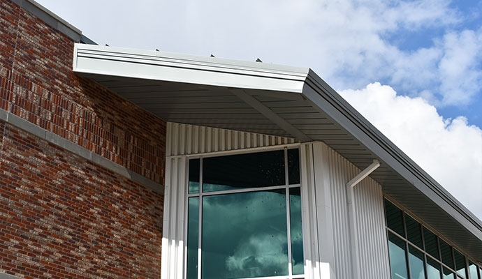 Clean and bright roof gutter system along the edge of a roof