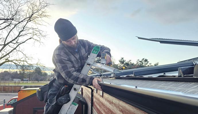 Expert installing gutter guard system