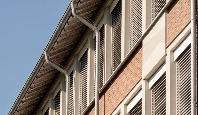 Clean metal commercial gutter system on a building exterior