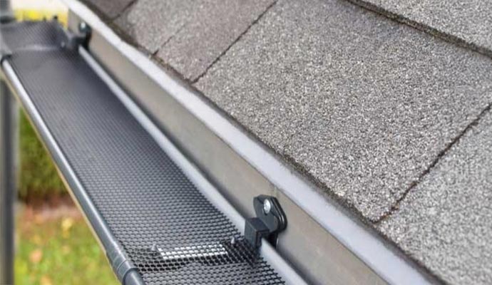 Installed gutter guards preventing overflow and directing water safely away from walkways and driveways.