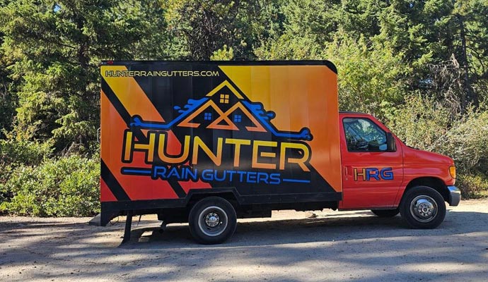 A branded Hunter Rain Gutters service truck parked outdoors, representing a trusted local gutter installation and maintenance company.
