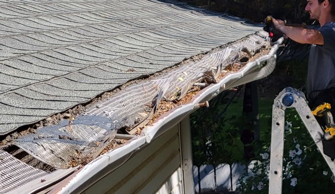 A professional repairing damaged gutter