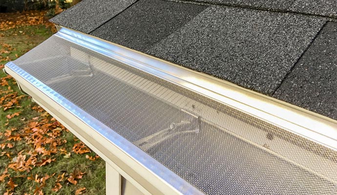 Fine stainless steel micro-mesh gutter guard screen installed over a residential gutter
