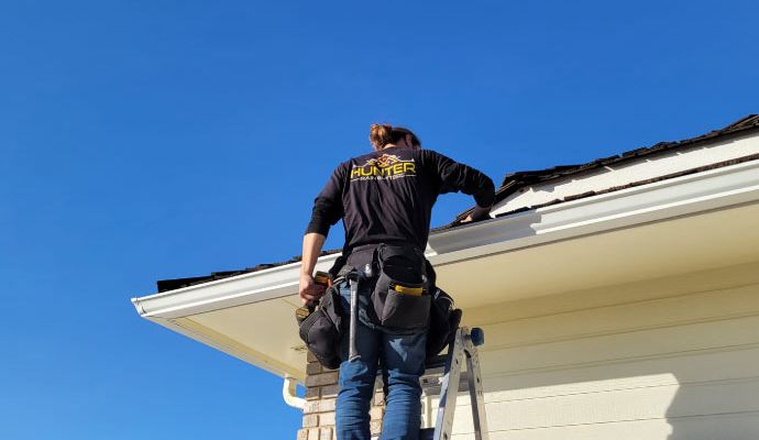Professional repairing a gutter