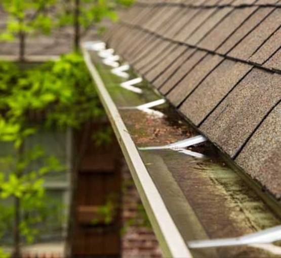 Rainwater overflowing from a clogged gutter