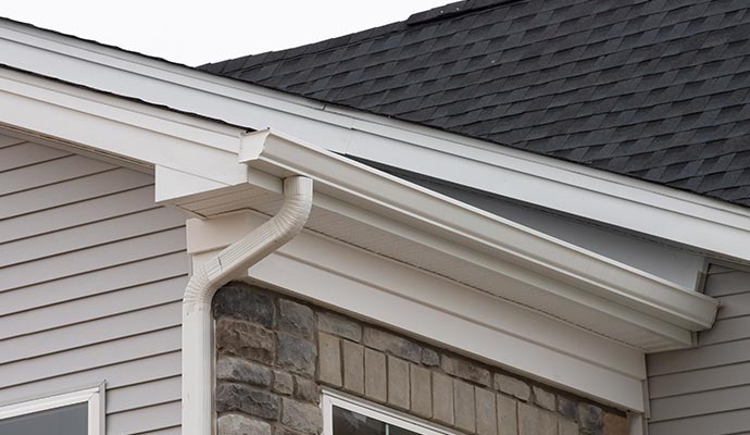 Seamless gutter system installed along a residential roofline