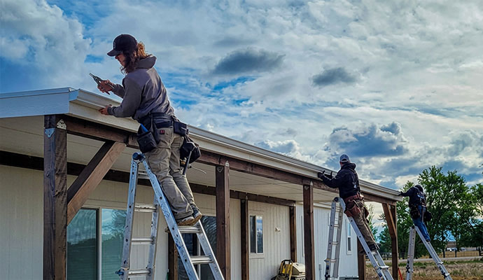Technicians installing new gutters