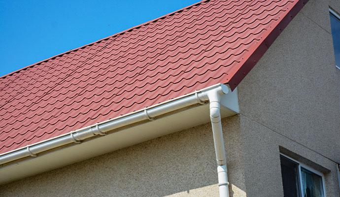 Vinyl gutters installed on a residential house with a roof