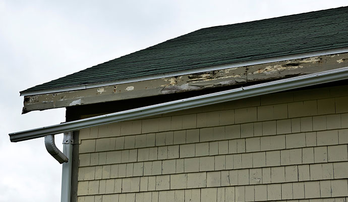 House roof with a damaged gutter system