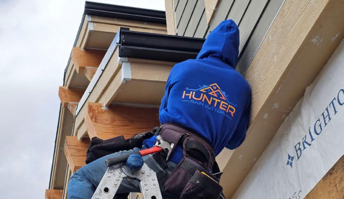 Professional gutter and fascia contractor at work