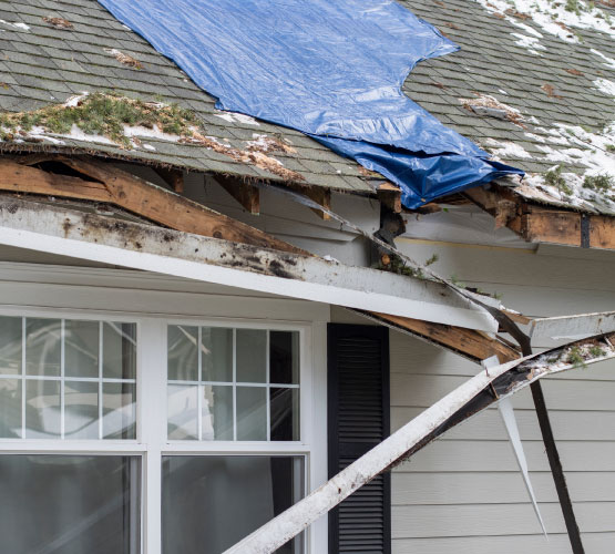 Storm damaged house roof tarp-cover