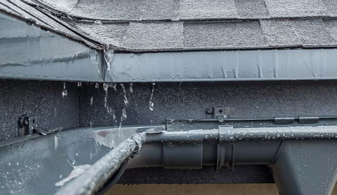 Rainwater drainage through a roof gutter system