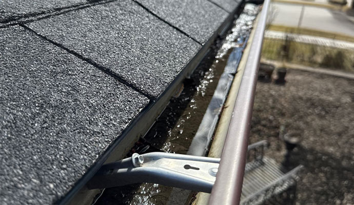 Roof gutter with standing water